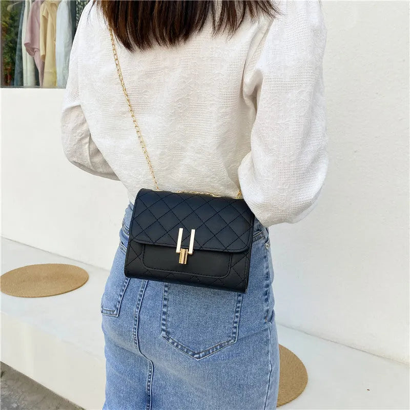 Women's crossbody bag with diamond lattice chain strap in black PU leather showing front view