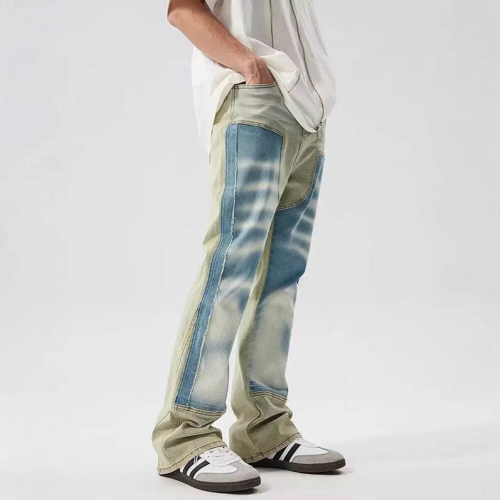 Retro yellow and blue patchwork jeans with splash-ink and damaged design details.