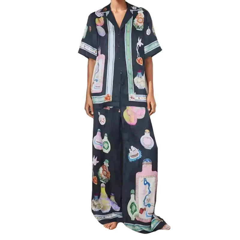 Black women's casual two-piece set with cartoon print, featuring cardigan and matching pants.