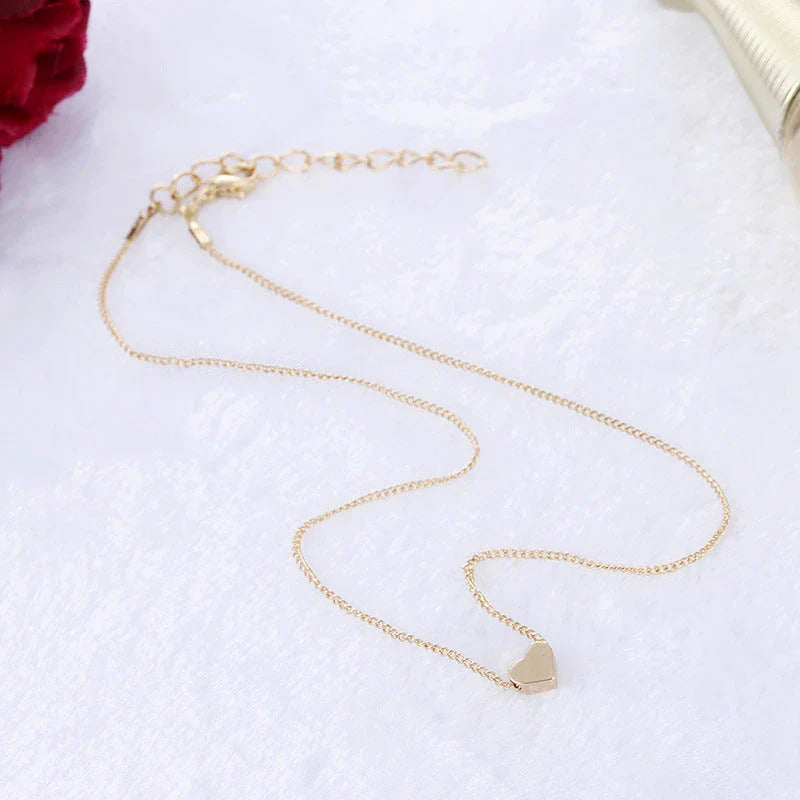 Elegant gold-tone double-sided love pendant necklace with clavicle chain, a versatile accessory for any outfit