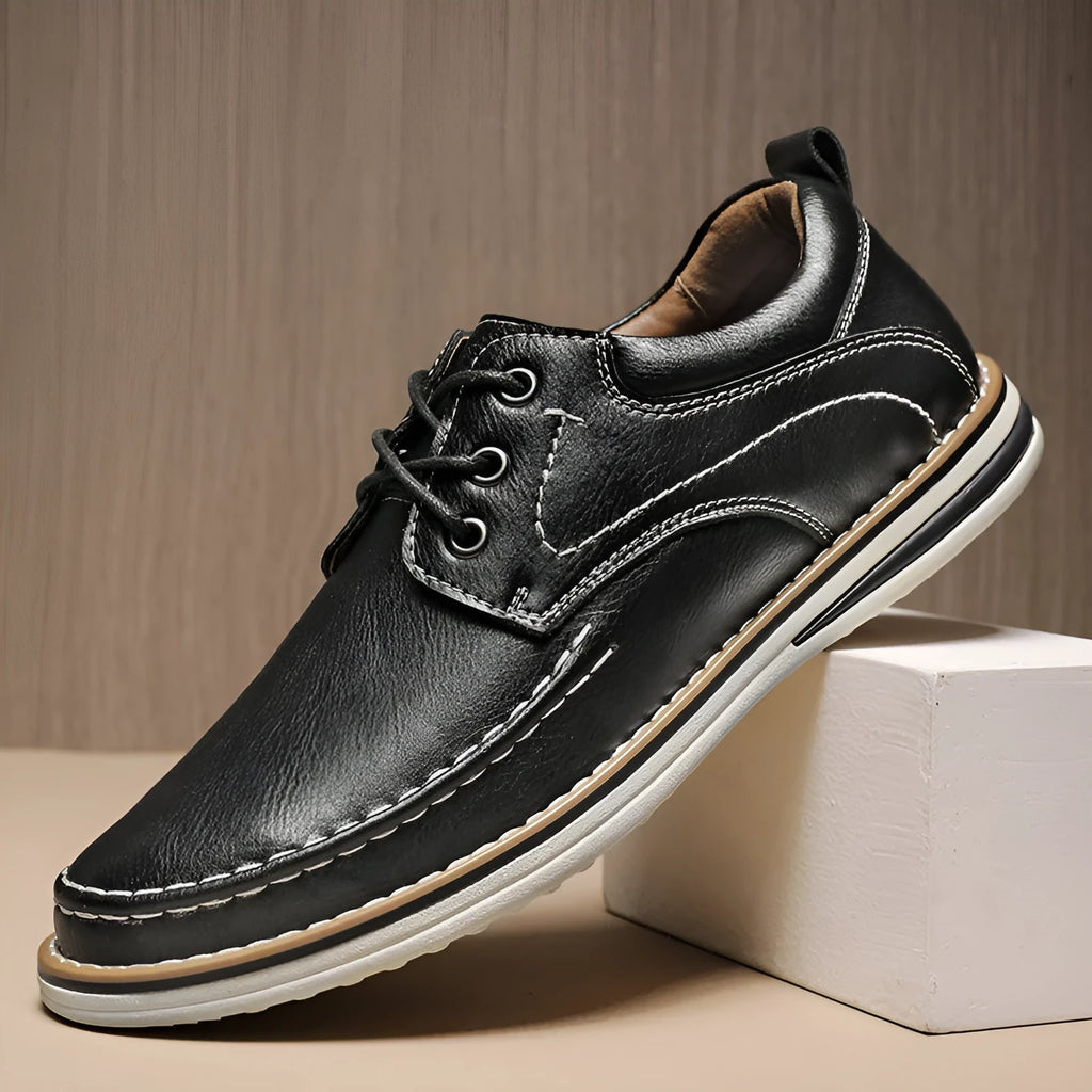 Men's black genuine leather lace-up casual shoes with round toe and low rubber sole on a white background.
