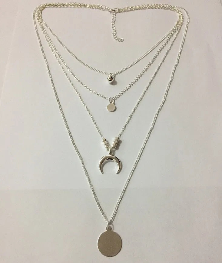 Geometric multi-layer moon disc pendant in gold alloy finish on a white background