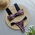 Women's leopard print tube top bikini set with matching T-pants on a mannequin.