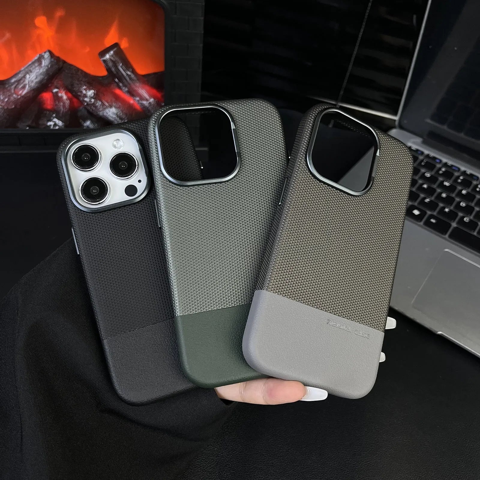Black iPhone case with dragon scale texture and leather stitching, showing built-in magnetic ring on the back.