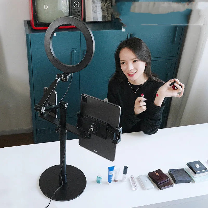 Black vertical floor stand with LED fill light holding mobile phone for filming