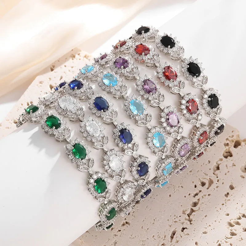 Simple electroplated alloy bracelet for women with inlaid zircon stone in one of nine colour options including ruby, emerald, and black onyx.