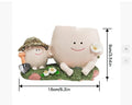 Ukulele-shaped resin succulent flower pot in office decoration setting.