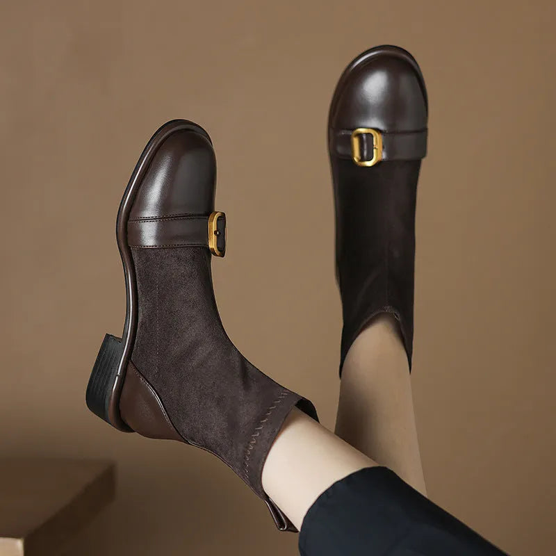 Women's black low heel Martin boot with lace-up front and decorative buckle stitching on a round toe.
