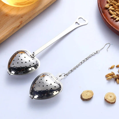 Heart-shaped stainless steel tea infuser with chain, perfect for steeping loose-leaf teas and spices