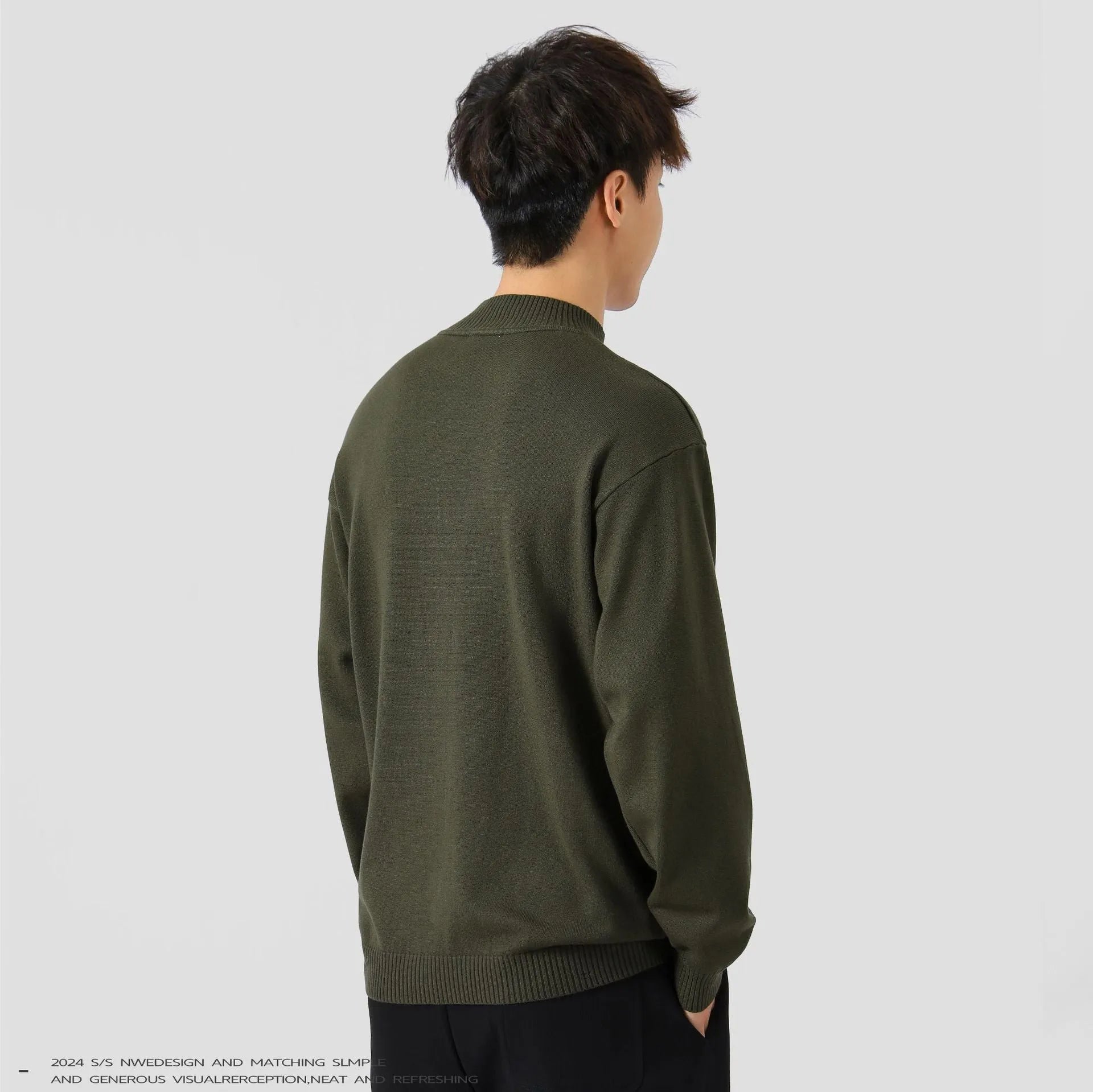 A man's loose-fitting solid colour long sleeve sweater in a chemical fibre viscose blend.