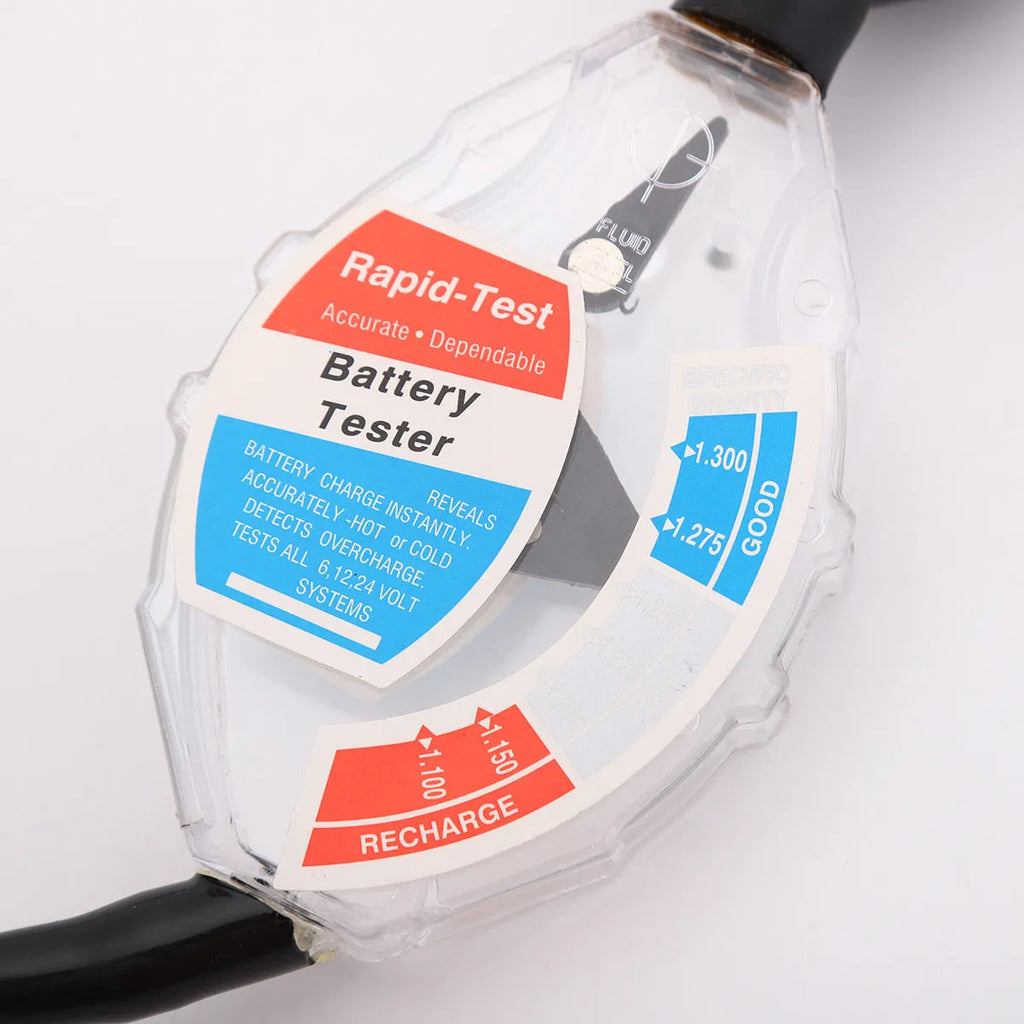 ABS plastic suction electrolyte hydrometer tool for lead-acid battery testing on a workbench.