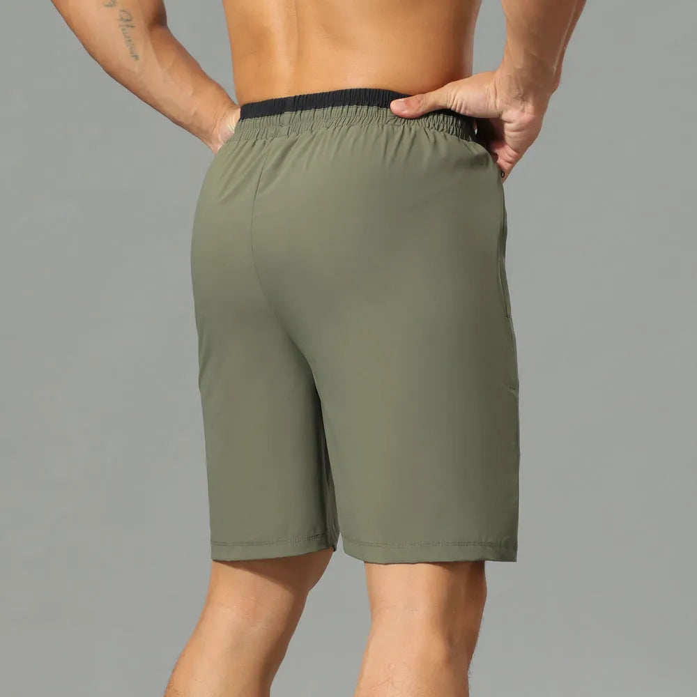 Man wearing grey loose-fit cropped Ice Silk pants for running or leisure.