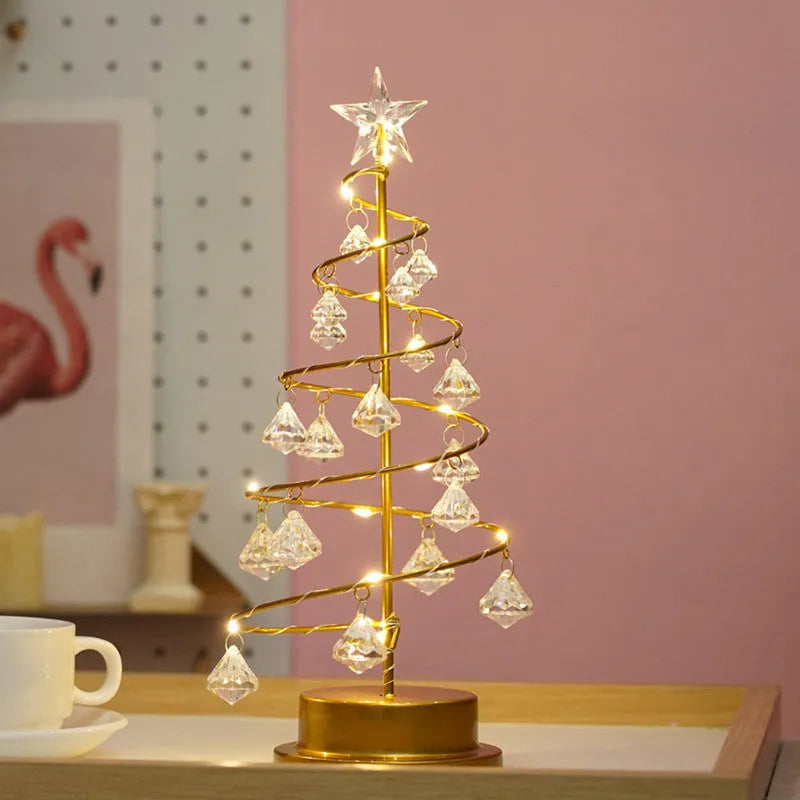 Gold crystal Christmas tree LED light with battery-powered warm glow on a shelf