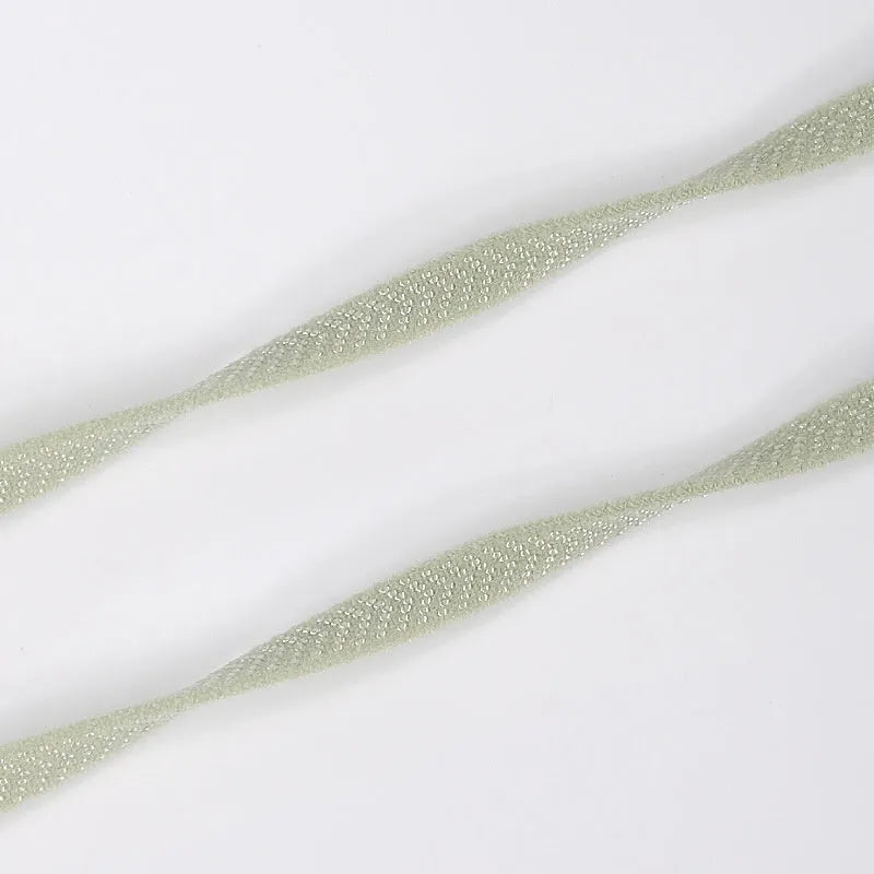 Flat elastic arrow pattern colour shoelace in black, 0.6cm wide, laid flat on a surface