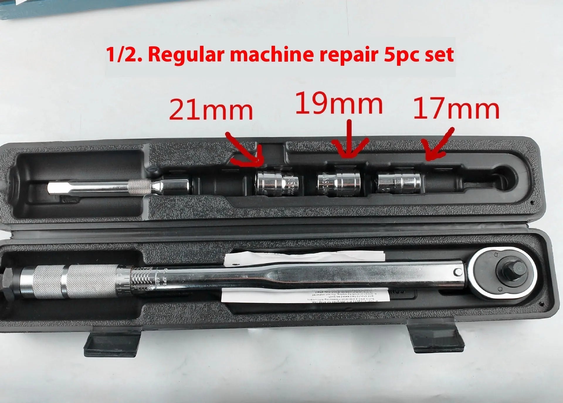Five-piece multifunctional torque preset torque wrench set with extension rods on a workbench