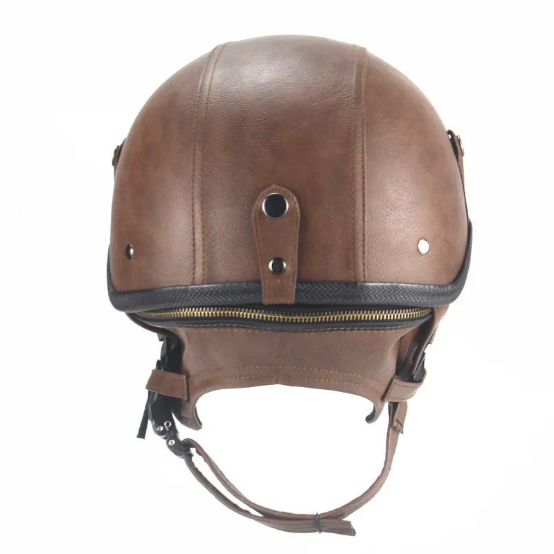 Black retro handmade leather half helmet for motorcycles on a plain background.