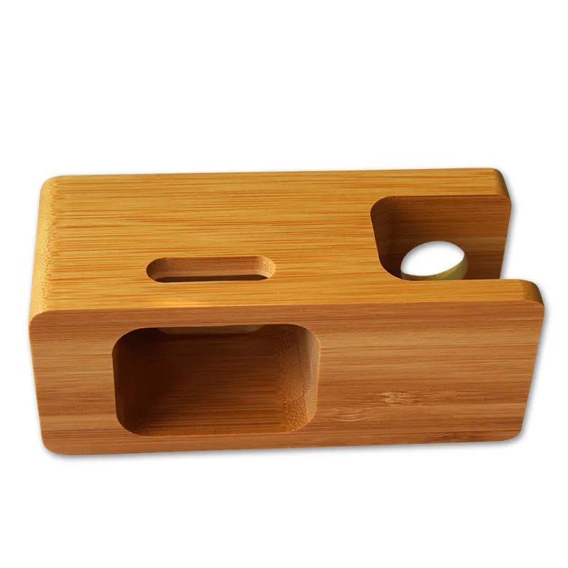 Natural bamboo smartphone stand with carved ornament detail on an office desk.