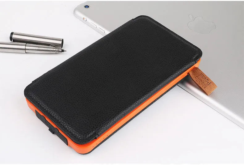 Outdoor solar power bank with waterproof black casing, solar panel, LED light, and USB ports