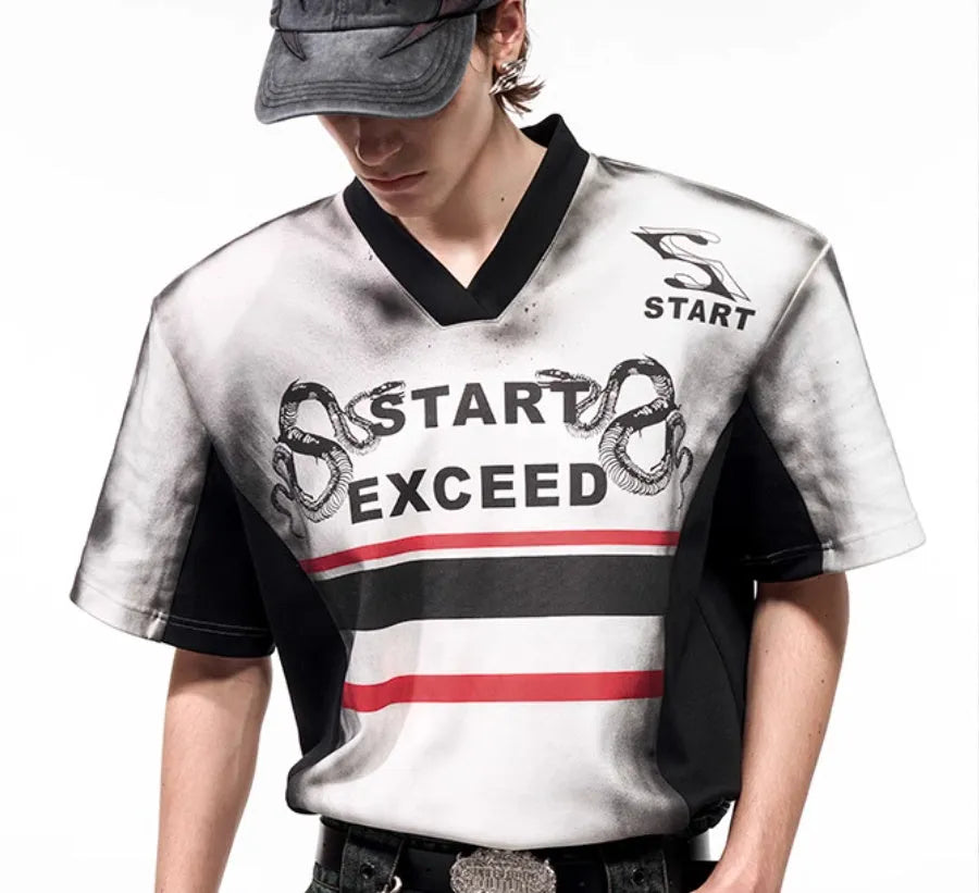 Women's V-neck short sleeve top with black and white letter snake pattern print and padded shoulders.
