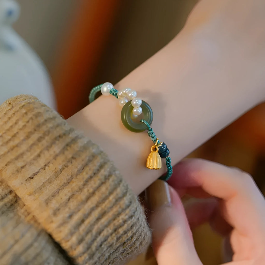 Hand-woven round watch band made from flexible wire with a Pearl Peace Buckle clasp
