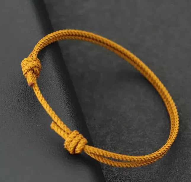 Handmade unisex adjustable string bracelet in yellow, red, or black with flexible wire and national style