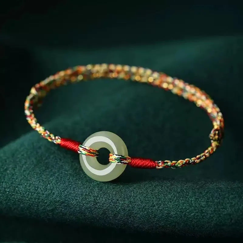 Colourful woven rope bracelet with silver peace buckle clasp on wrist