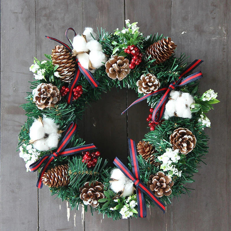 Festive Christmas wreath with artificial pine cones, berries, and maple leaves for elegant holiday decor