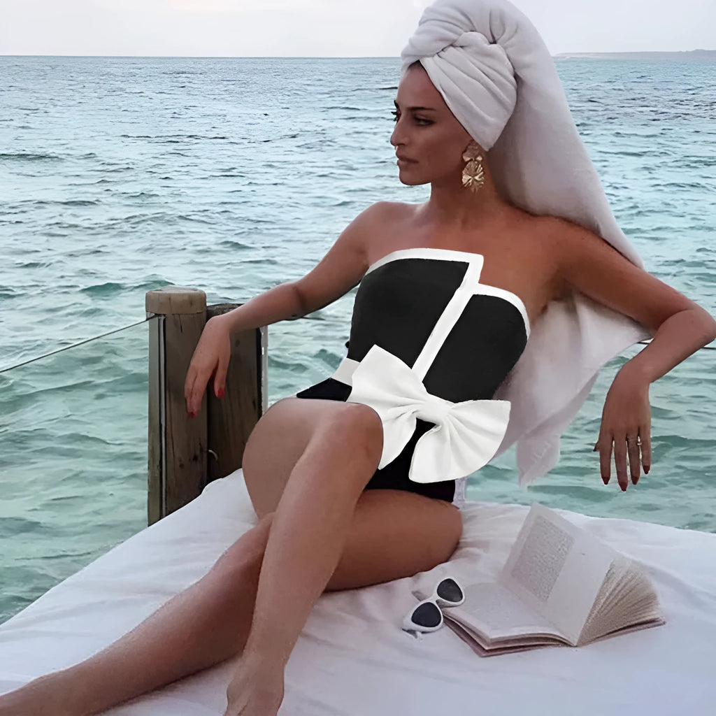Women's black and white colour-block one-piece swimsuit with asymmetric bow detail