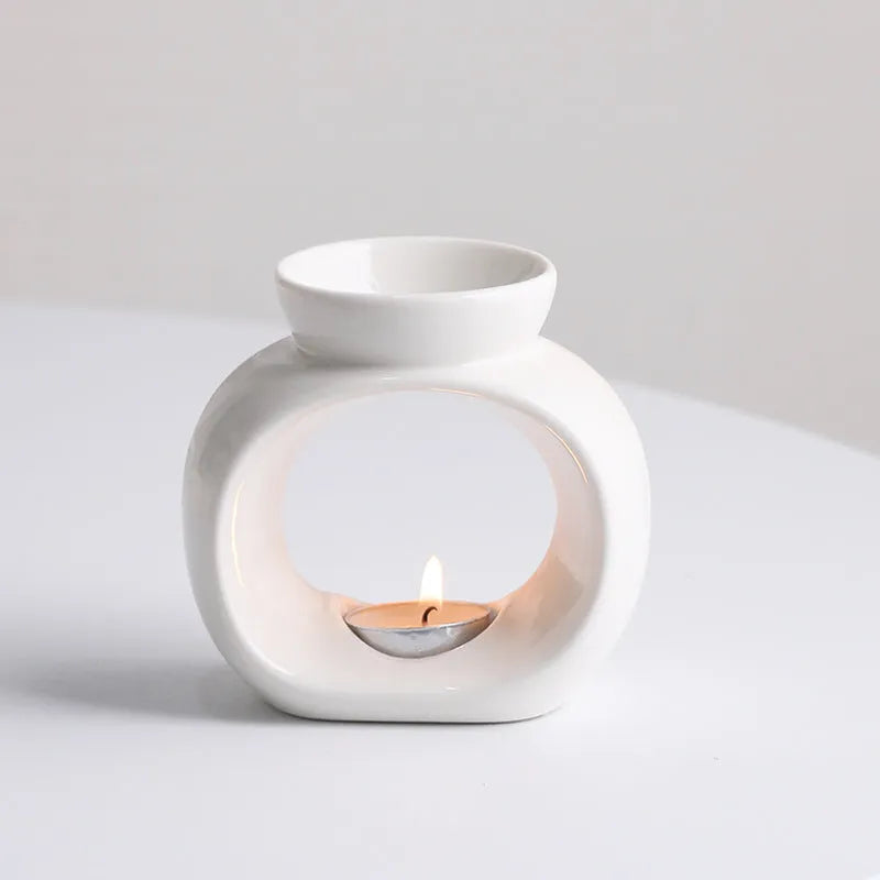 White glazed porcelain Nordic style aromatherapy stove ornament on a table.