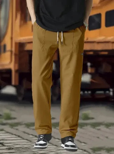 Men's light grey casual chino-style trousers made from polyester for spring and autumn wear.