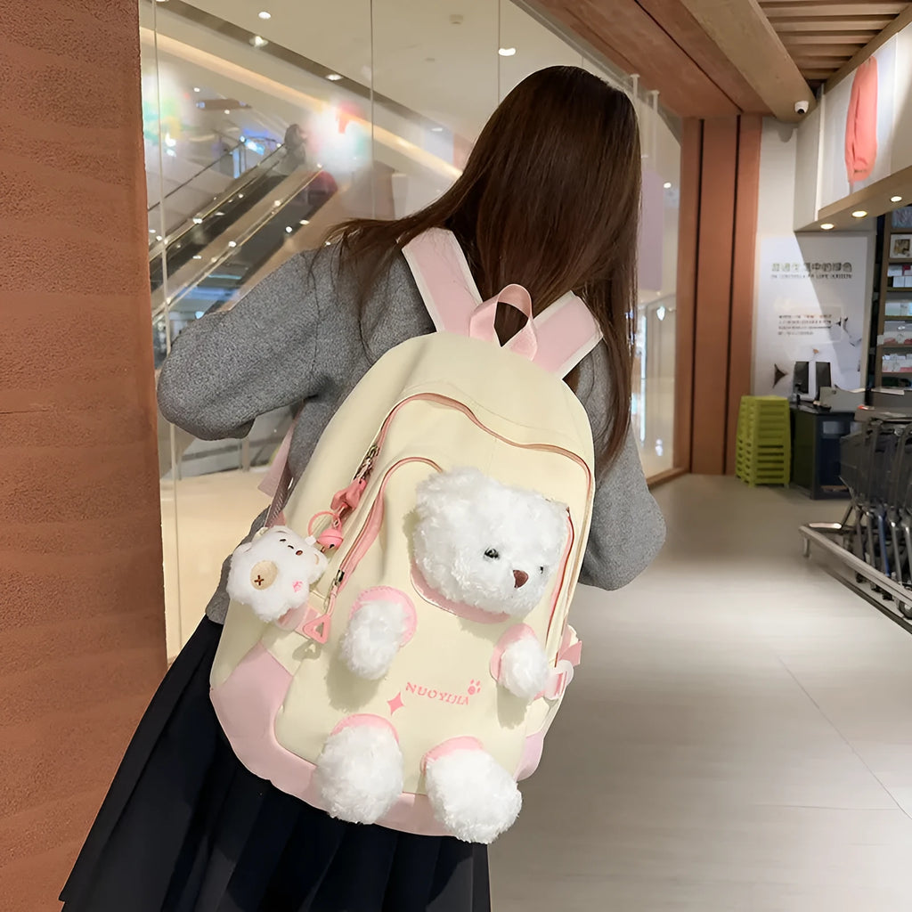Yellow pink nylon backpack with bear design and curved shoulder straps, 20-35L capacity.