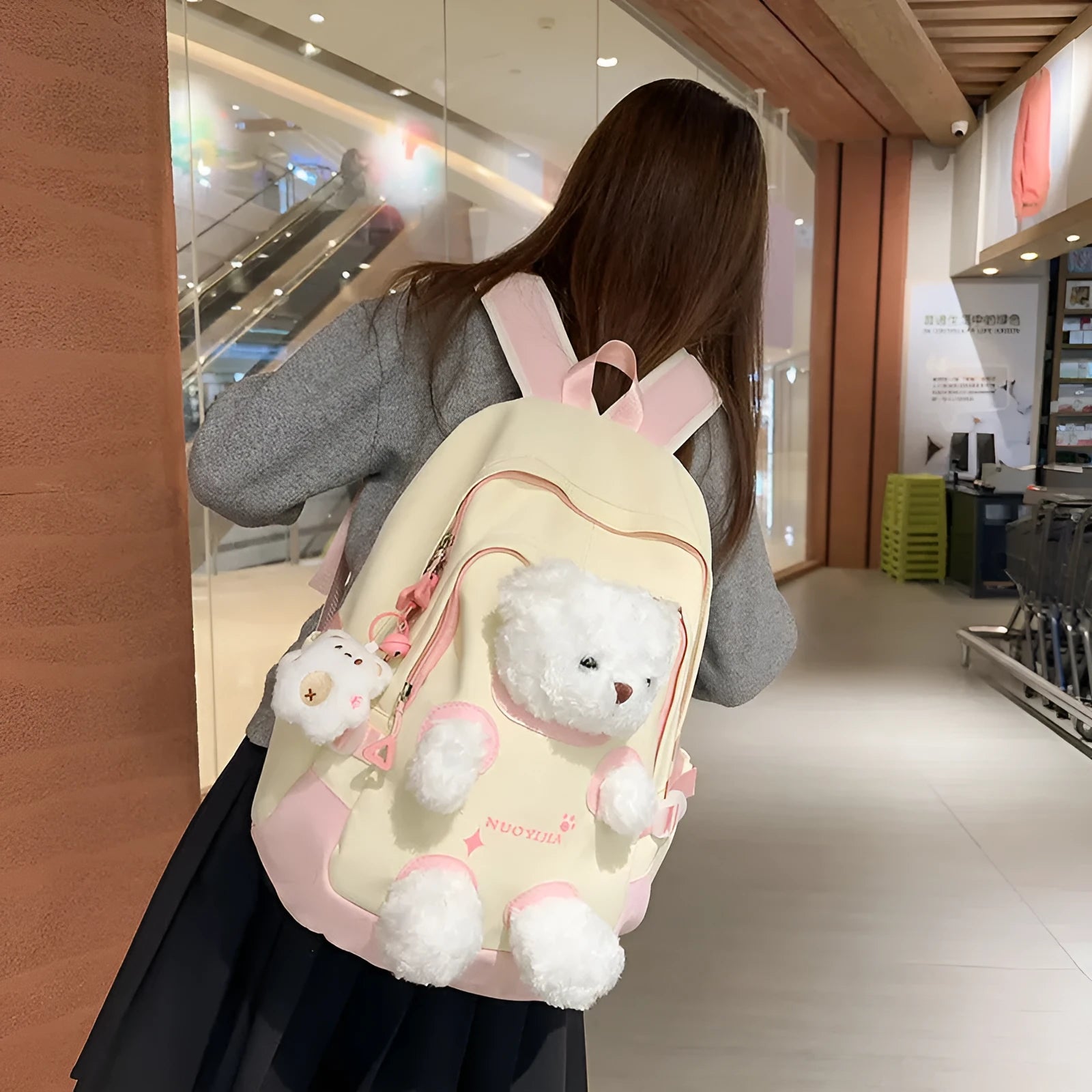 Yellow pink nylon backpack with bear design and curved shoulder straps, 20-35L capacity.