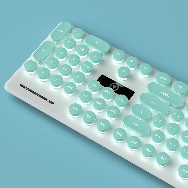 Punk style luminous keyboard in mint green with white backlit keys on a desk.