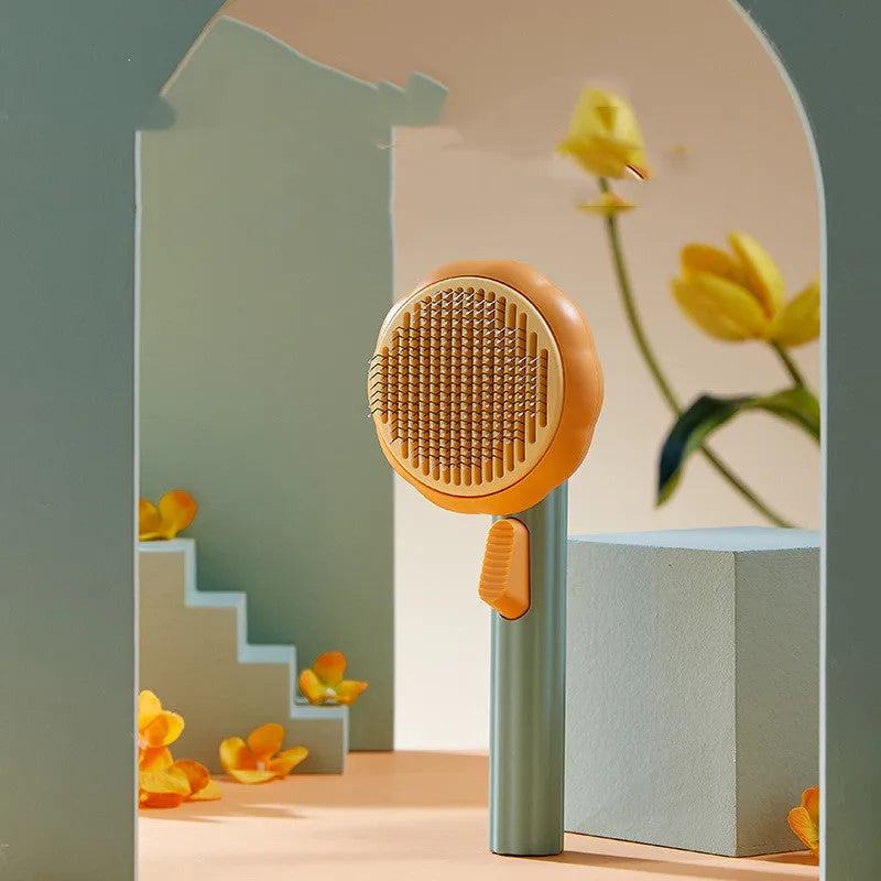 Hand-held pet grooming brush with stainless steel needles in pumpkin colour design