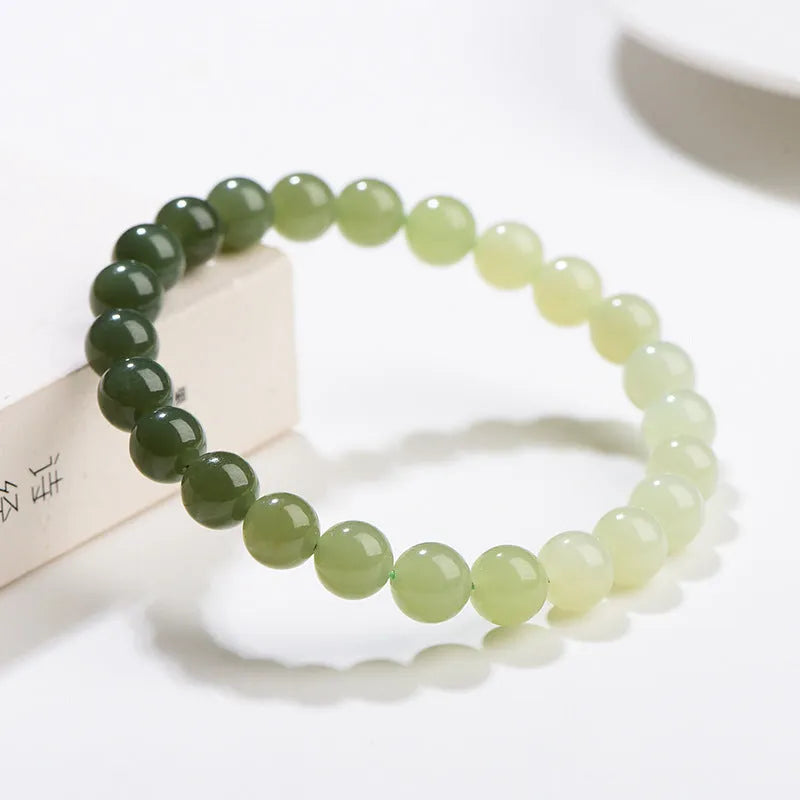 Natural clear water Hetian jade ball bracelet with round and barrel bead options.