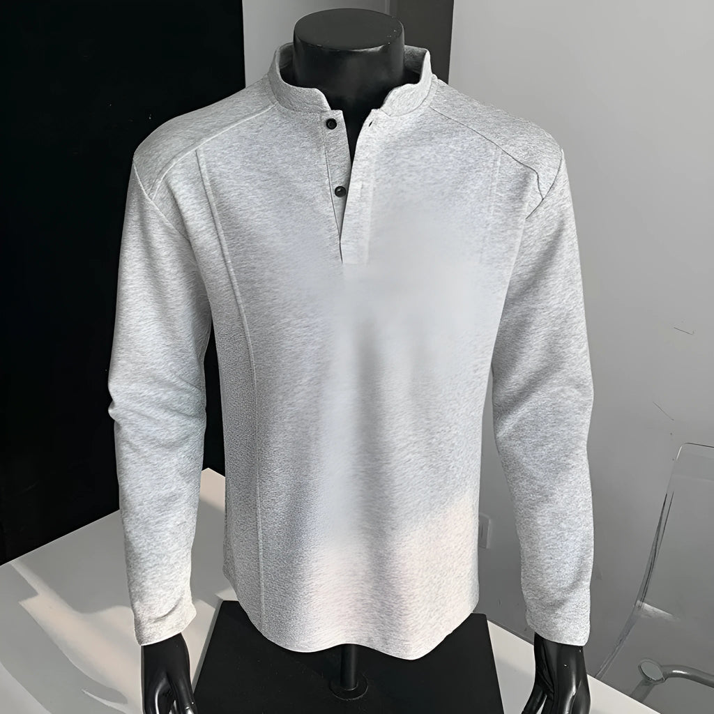 Men's grey polo shirt with patchwork detailing on shoulders and stand-up collar