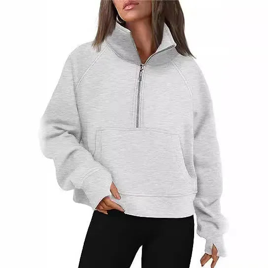 Woman wearing a loose lapel fleece-lined sweater in a solid colour, showing raglan sleeve detail.