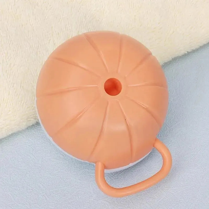 Orange dog bath brush with shampoo dispenser and soft TPR bristles on a curved pumpkin-shaped handle.