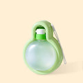 Green portable dog water bottle with pull-out drinking bowl on a table