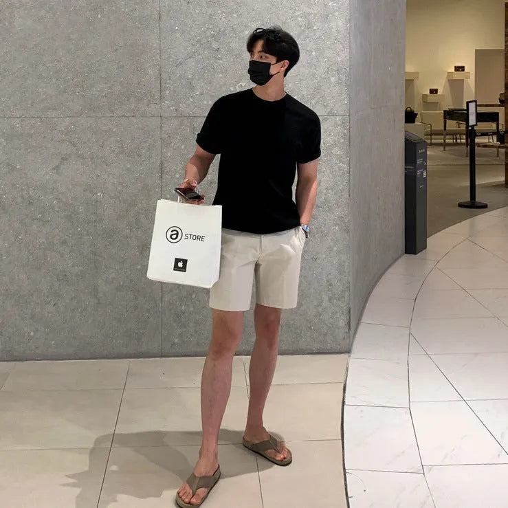 Man wearing loose straight-leg casual shorts in solid khaki colour