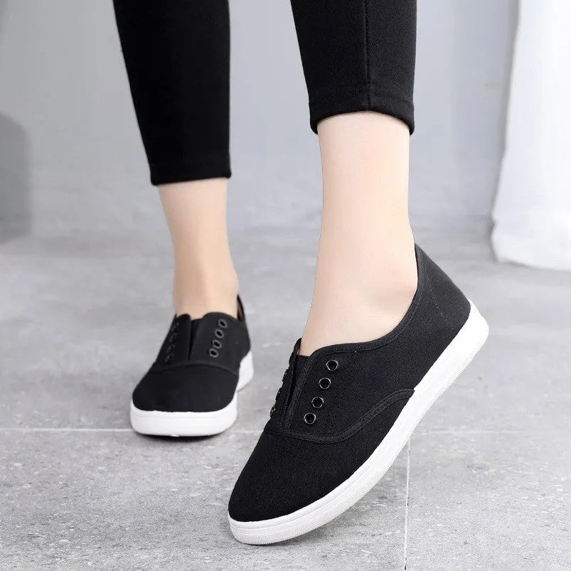 A pair of low-top canvas casual shoes in black with a flat plastic sole