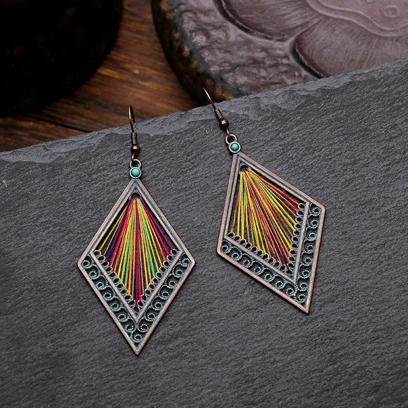 Bohemian hand-woven gold thread alloy earrings with geometric quadrilateral shape on a white background