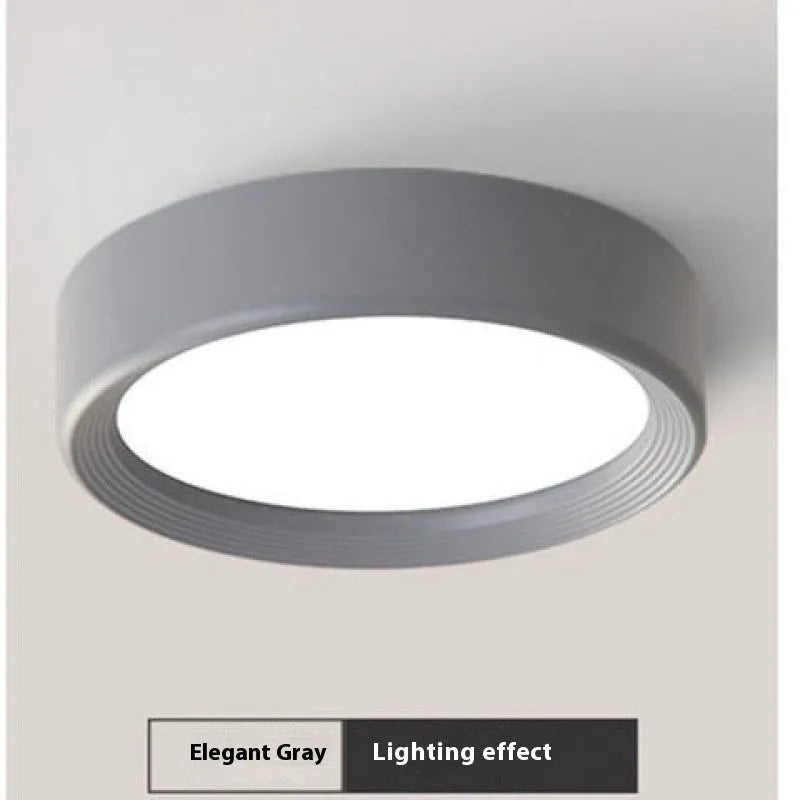 Ultra-thin surface mounted LED downlight in a choice of seven colours including black, white, gold, and pink.