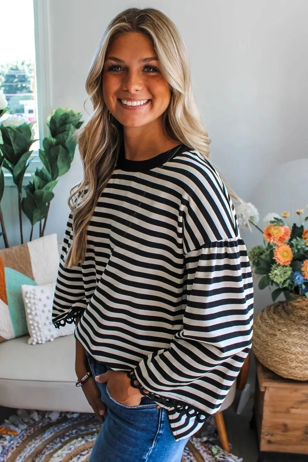 Women's striped crew neck long sleeve top in black loose fit polyester front view