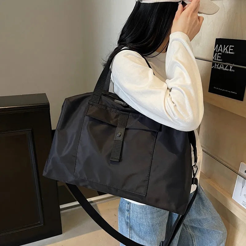 Grey one-shoulder Oxford cloth travel bag with 36-55L capacity and breathable lining
