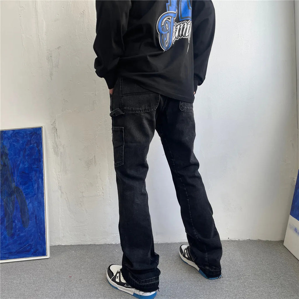 Women's micro flared patchwork raw edge jeans in black denim with loose straight tube fit, front view