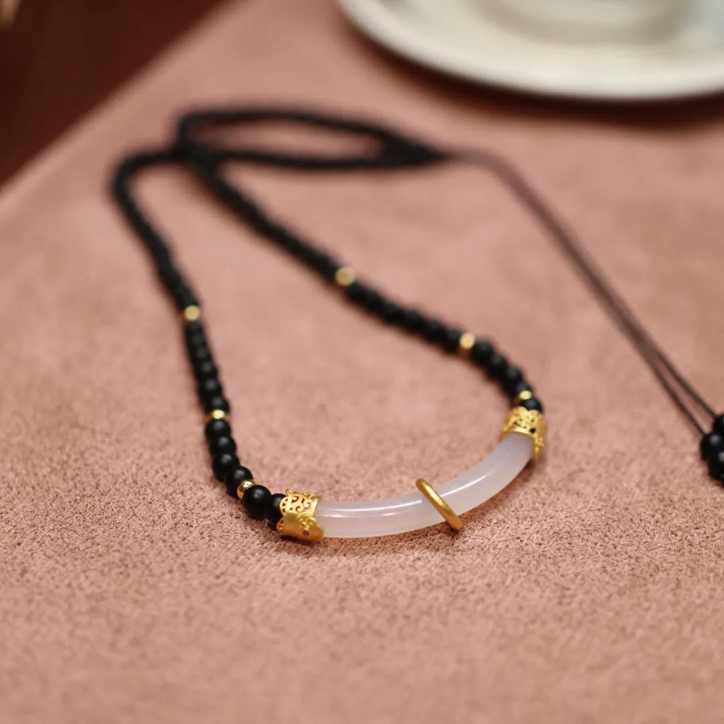 Natural frosted black agate and white chalcedony necklace with silver pendant on ball bead chain.