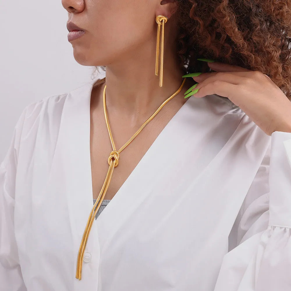 Gold knotted tassel snake chain long necklace with matching electroplated earrings on titanium steel