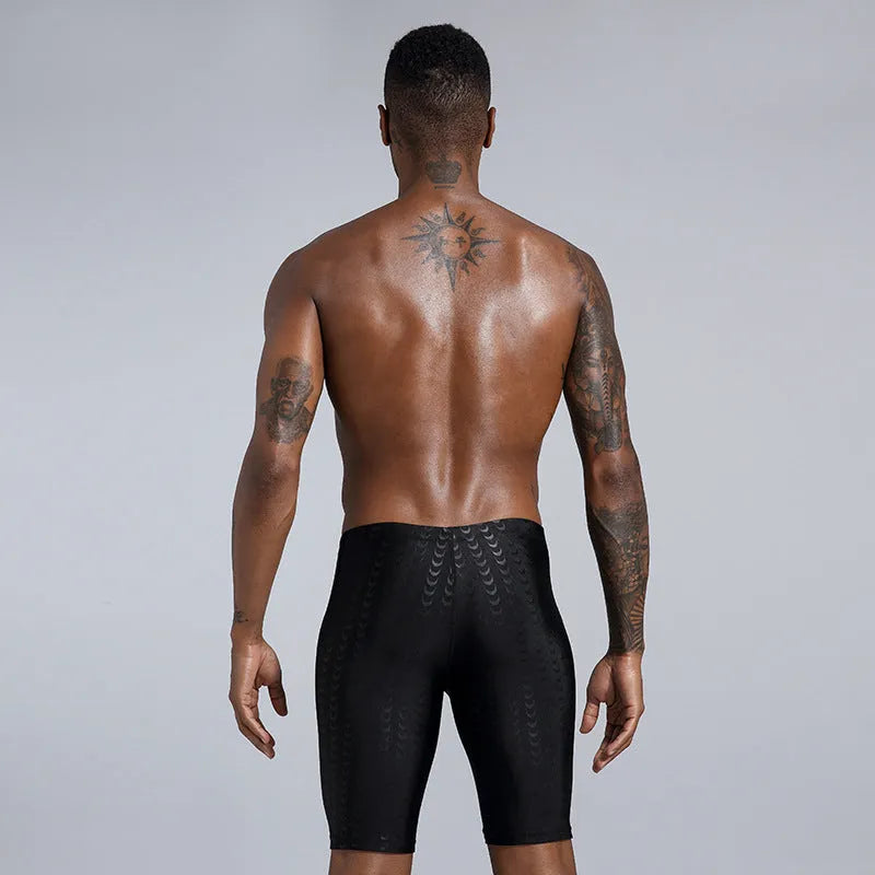 Men's solid colour shark skin texture waterproof swimming trunks for surfing, shown in sizes XL to 4XL.