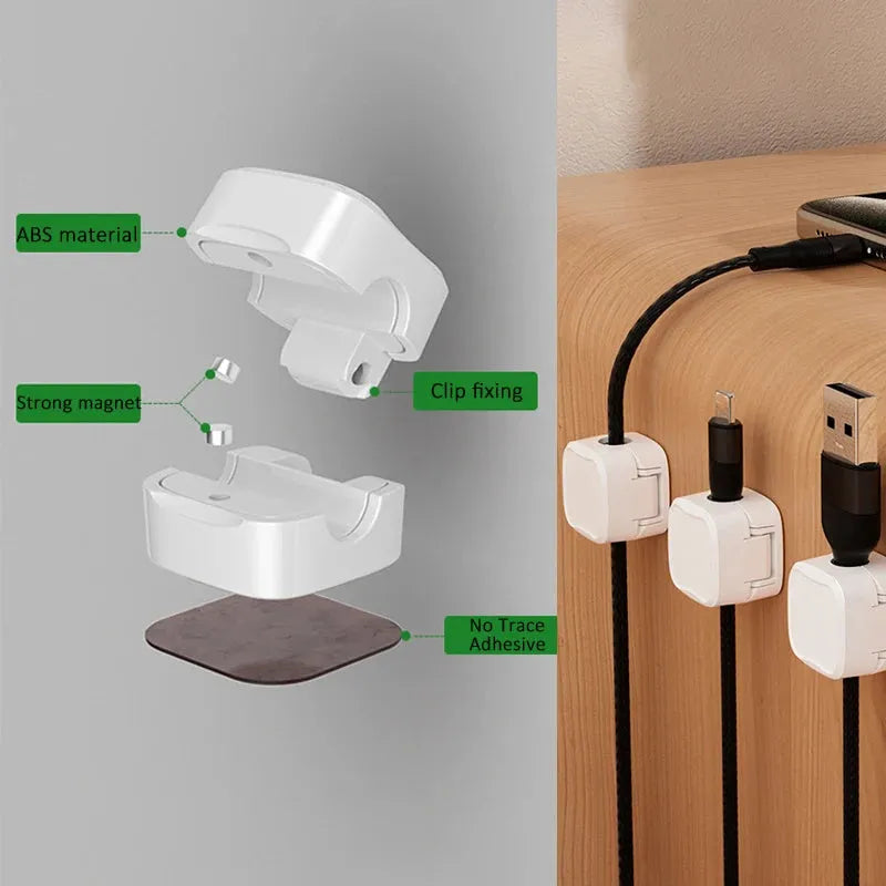 White and black magnetic cable clips with adhesive backing organising multiple cables under a desk